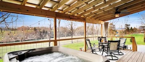 Enjoy the relaxing hot tub that overlooks a river and pastoral farmland.