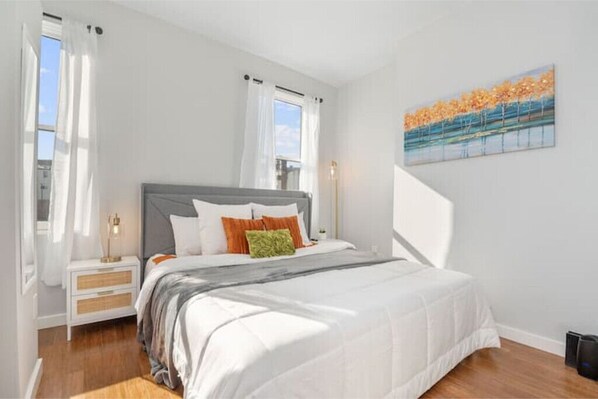 Comfortable King Size Bed with blackout curtains in the bedroom. 

