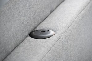 Charging station in headboard of bed. 