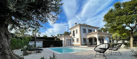 Picturesque view of the villa from the beautifully designed, landscaped gardens.