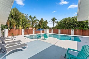 Soak up the sun in comfortable patio chairs by the pool, the perfect spot for ultimate relaxation.