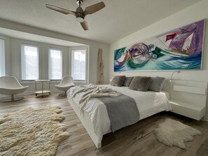 Primary Bedroom with King bed, stunning art, and blackout blinds.