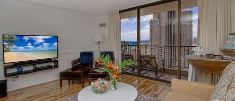 comfortable living room with queen sofa bed and amazing ocean and sunset views from balcony