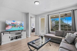 Experience comfort and entertainment in our inviting loft living area with a sofa and TV.