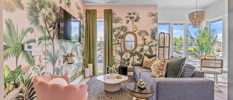 Indulge in the allure of paradise with this exquisite tropical-inspired living room. Vivid bursts of color, exotic prints, and breezy elements converge to form a vibrant ambiance, transporting you to a distant beach destination.