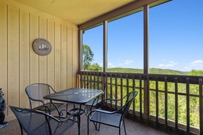 Screened-In Balcony with Comfortable Seating and Table