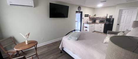 Full apartment showing TV and AC unit