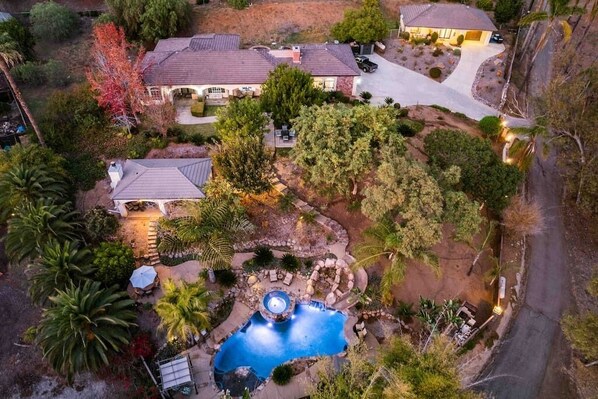 This gated 2 Acre Estate it  feels like paradise. It is a hidden gem and oasis in the foothills of Vista. Relax in the gorgeous resort style pool with waterfall, slide, Jacuzzi, enjoy 
The outdoor cabana with fireplace, full bar, barbecue & smoker