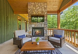 Cozy up! Our cabin’s deck is perfect for sipping your morning coffee by the warmth of the outdoor fireplace, with nothing but the gentle rustle of leaves around you.