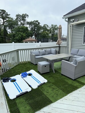 Kick back and relax on the back deck. Enjoy the view of the pool or cornhole!