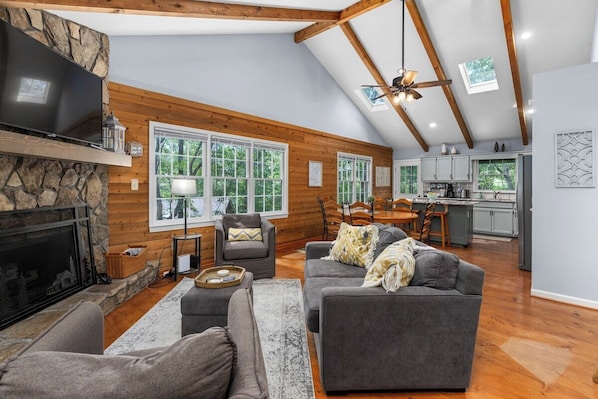 Living Room: Experience bright open spaces with rustic charm and stunning nature views!