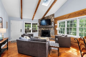 Living Room: Enjoy the stunning views through large windows and relax by the beautiful stone fireplace!