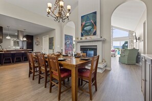 Elegant dining room seats 8 with chandelier and dual wood burning fireplace.