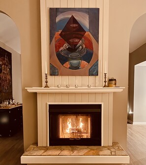 Sit by the warm wood burning fireplace and enjoy the original art work.