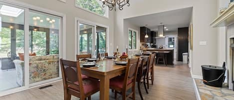 Elegant dining room in between the wood burning fireplace and the sunroom!
