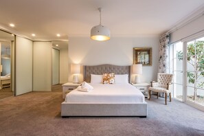 The primary bedroom is a luxurious ground-floor sanctuary with a king bed, an en-suite and private courtyard.