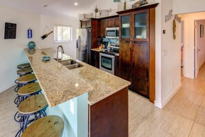 Stainless steel appliances and granite countertops infuse elegance into the kitchen space.