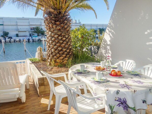 Table, Furniture, Water, Property, Sky, Chair, Tableware, Azure, Outdoor Furniture, Plant