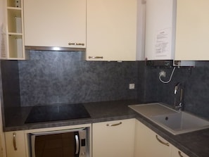 Countertop, Property, Room, Sink, Tile, Cabinetry, Kitchen, Furniture, Wall, Brown