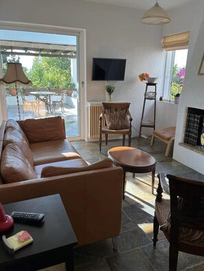 Living Room with Smart TV and slider glass windows to both front & back veranda.