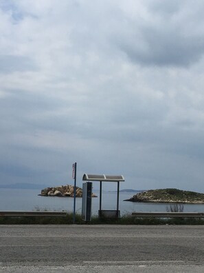 150 meters walk the Rte 122 bus stop beside the sea, to  Athens metro or South 
