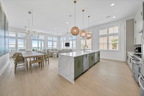 Large open kitchen, living, and dining room on the first floor.