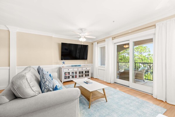 Brass Rail 315 - Living area with sleeper sofa, TV and access to balcony