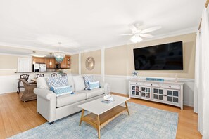 Living area with sleeper sofa, TV and access to balcony