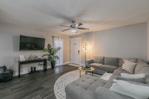 Cozy living room w/ ample seating -shaped sofa and blankets for chilly evenings