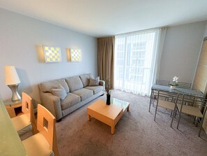 Spacious living area with dining space and floor-to-ceiling windows