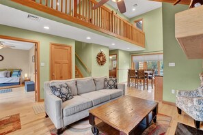 living room and dining area with fireplace, bay window and wooden touch.