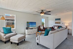 Relax in the large, open-concept Living Area with a Flat Screen TV and plenty of cozy furniture.