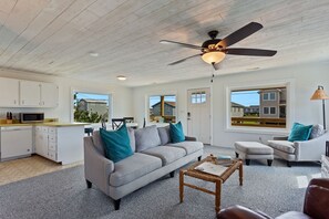 Relax in the large, open-concept Living Area with a Flat Screen TV and plenty of cozy furniture.