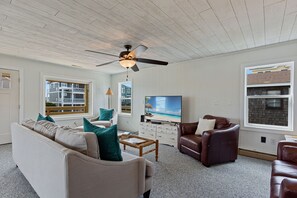 Relax in the large, open-concept Living Area with a Flat Screen TV and plenty of cozy furniture.