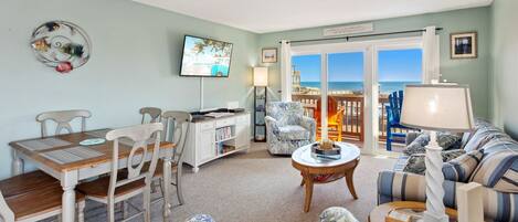 Relax in the spacious Living Area with a Flat-Screen TV and ocean views!