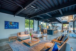 Living room, kitchen and breakfast bar in background
