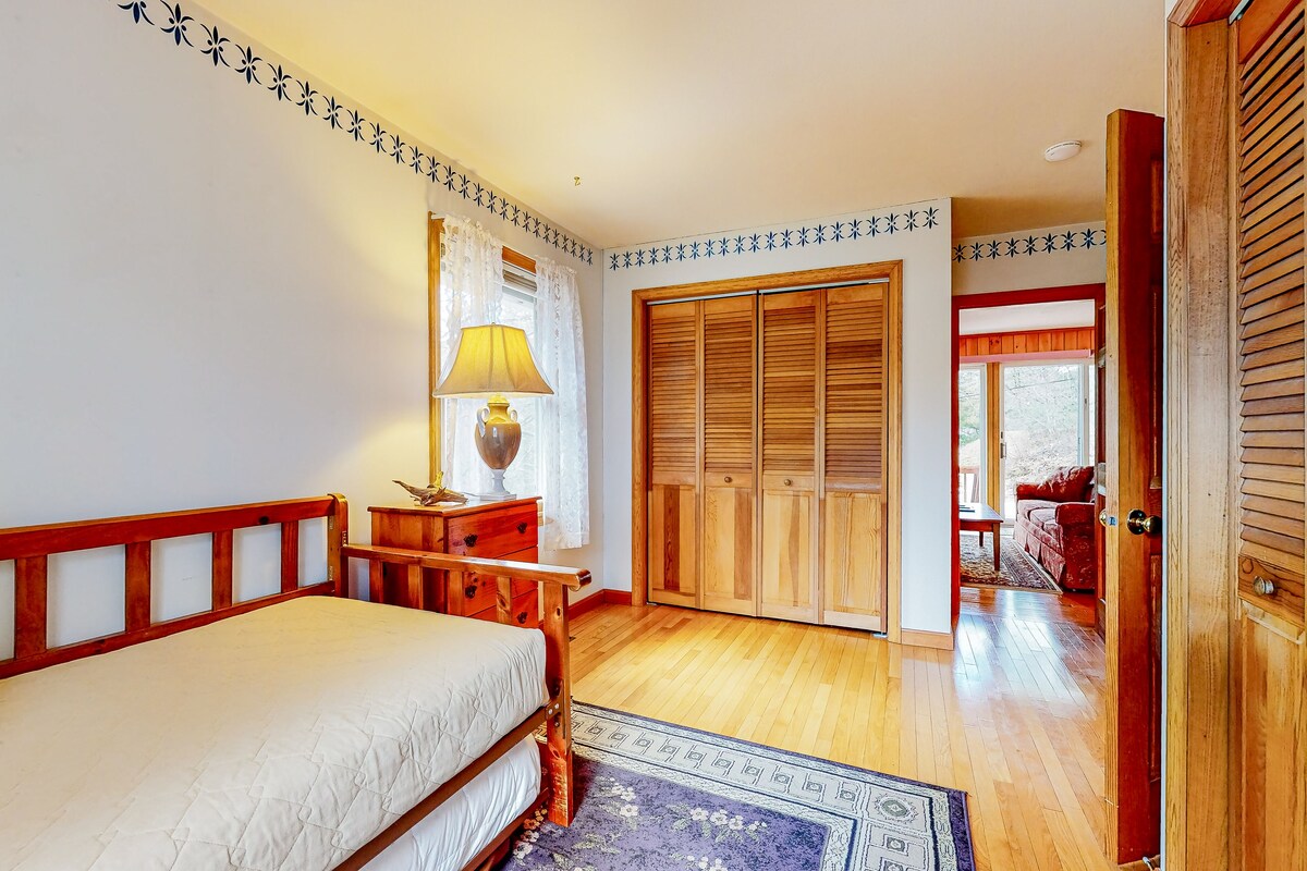 Calming dog-friendly lake view home with firepit, wood stove, patio, & gas grill