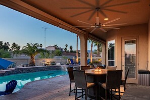Covered patio near the pool with fire pit