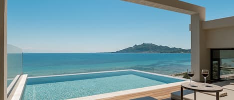 The iconic infinity roof-top pool reigns sublimely over the Ionian Sea. 