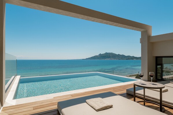 The iconic infinity roof-top pool reigns sublimely over the Ionian Sea. 