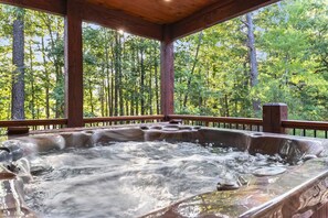 Unwind in the bubbling hot tub while taking in the breathtaking forest views. It's the perfect spot for relaxing after a day of exploring the great outdoors.