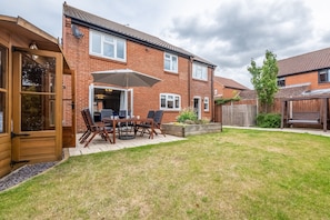 Langdale, Heacham: Fully enclosed rear garden with outdoor furniture and summer house