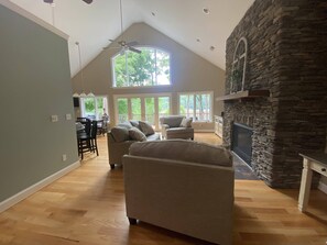 Main level living room with wall of windows with lake view