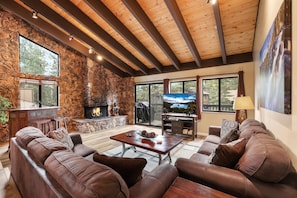 Cozy and spacious living area with TV and fireplace