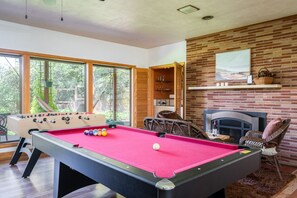 Great room with pool table, foosball, bar,  gas fireplace and more…