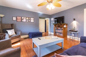 The living room is spacious and brightly lit. It features a 48"+ TV. You can log into YOUR streaming service accounts such as Netflix, Hulu, Disney+. It also features free channels through Sansung Plus.