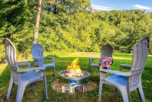 Fire pit just outside of front porch, near the charcoal grill