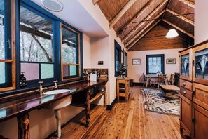 High A-frame wooden ceilings, timber furniture and tall windows makes this space feel airy, natural and harmonious.
