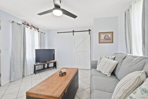 Comfortable couch in back living room doubles as a pull-out bed
