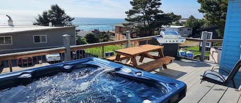 6 person hot tub with ocean view, BBQ, chairs and 6 person table